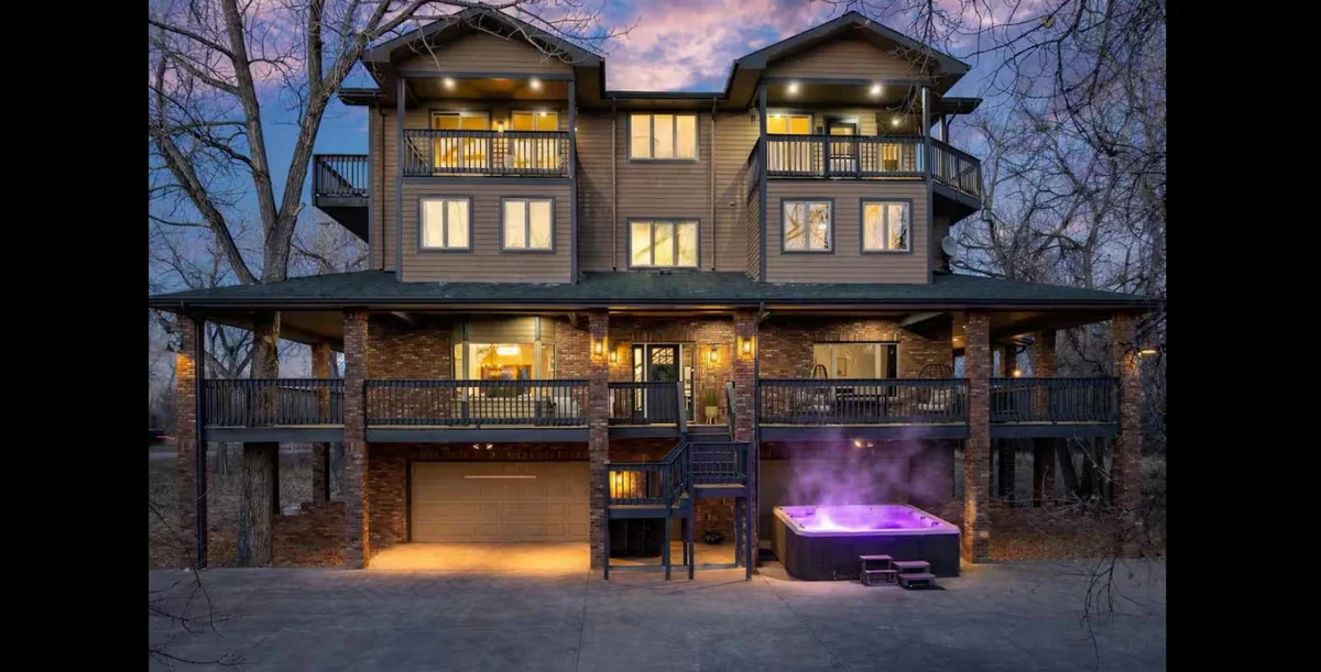 Exterior of the wedding-week Airbnb with balconies and a hot tub